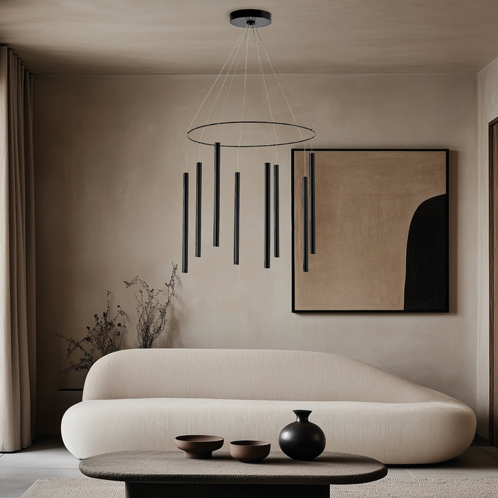 Mika Chandelier in black above a curved cream sofa with abstract artwork and low table