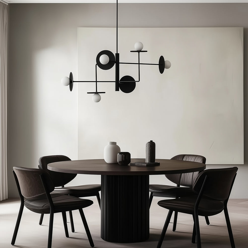 Black pendant with opal globes and black discs over a round dark wood dining table