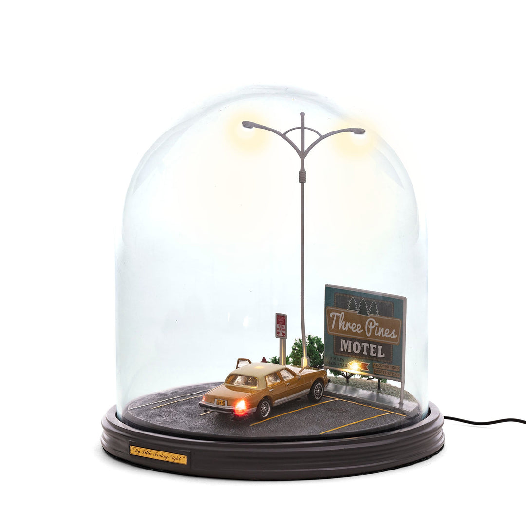 Seletti My Little Friday Night, night scene of a car parked by a lit motel sign and street lamp under a large glass dome