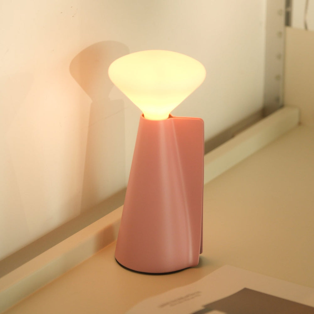Pink modern table lamp with soft glow, sleek design for elegant home decor