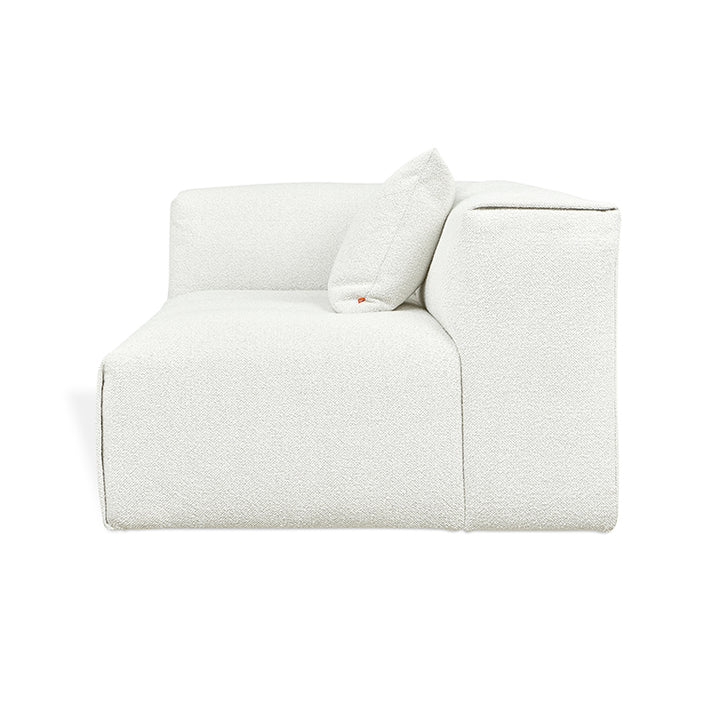 Elegant white textured modular sofa with designer cushion, blending modern comfort and refined aesthetics.
