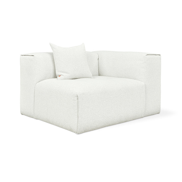 White bouclé modular armchair with plush cushion, minimalist design for modern living spaces