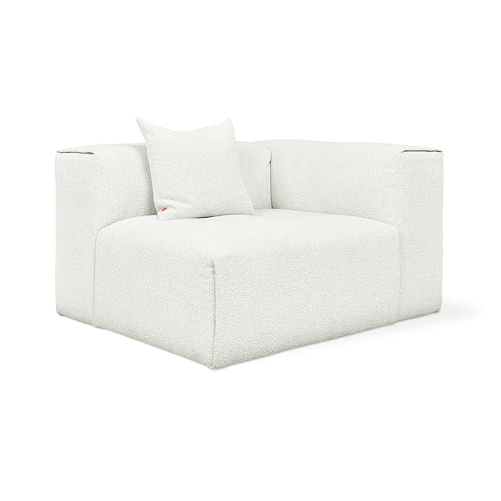 White bouclé modular armchair with plush cushion, minimalist design for modern living spaces