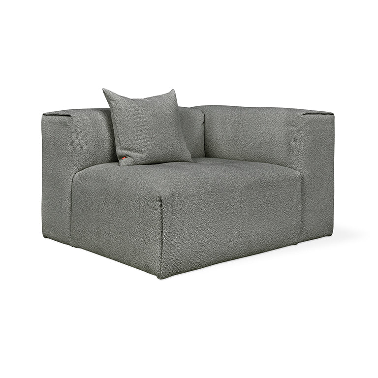 Modern gray bouclé armchair with plush cushion, minimalist design for contemporary living spaces