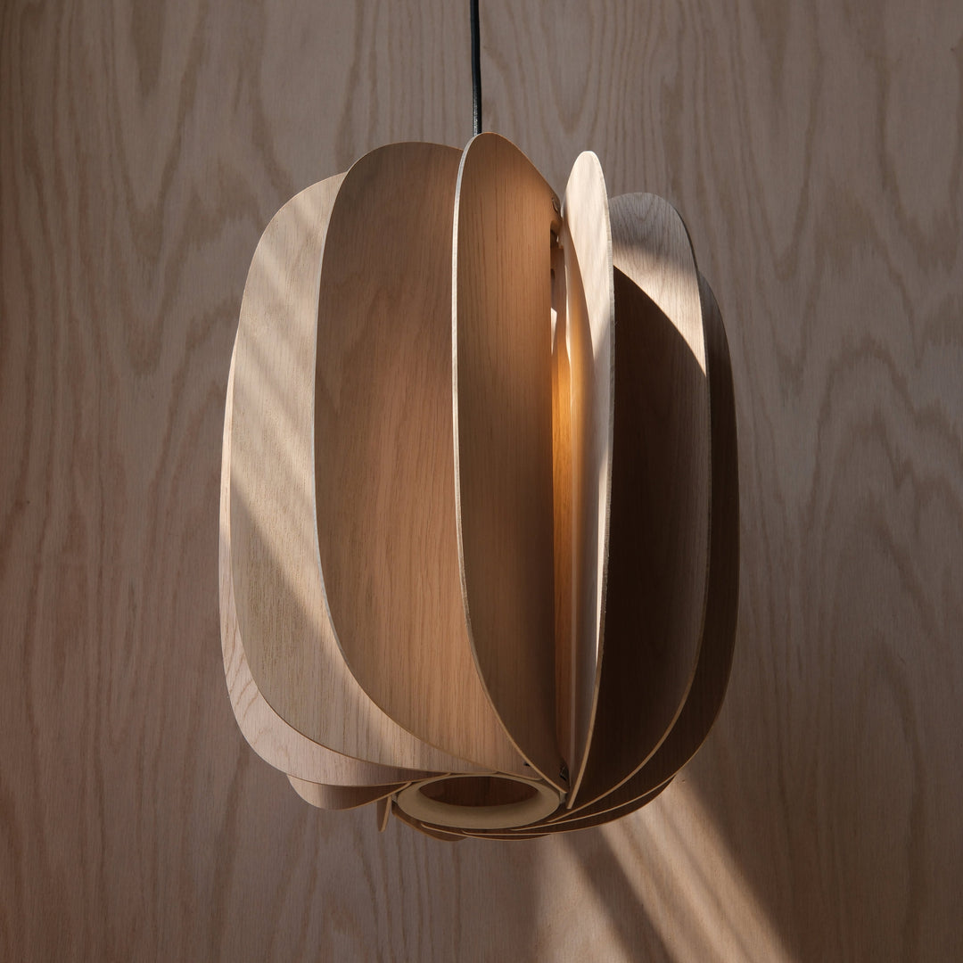 Elegant wooden pendant light with layered petal design, warm ambient glow