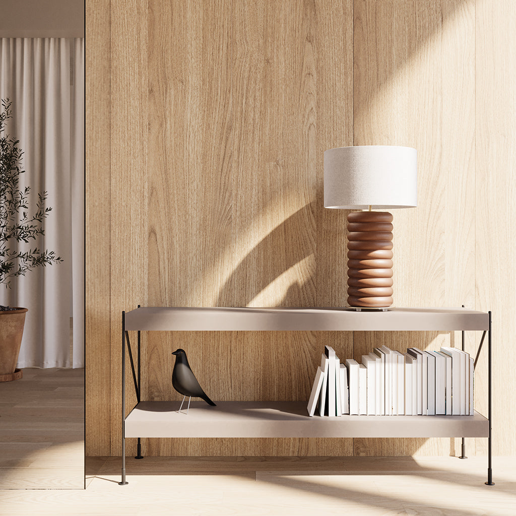 Onut Table Lamp, Double, in terracotta ceramic on a metal console with books against wood panelling