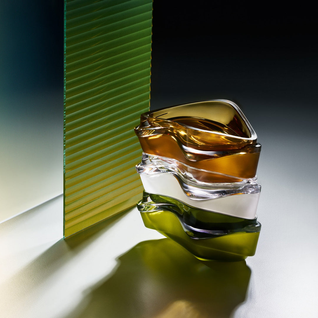 Plex Vessel, Set of 2 — Amber, clear and Olive Green vessels stacked beside ribbed glass in dramatic light