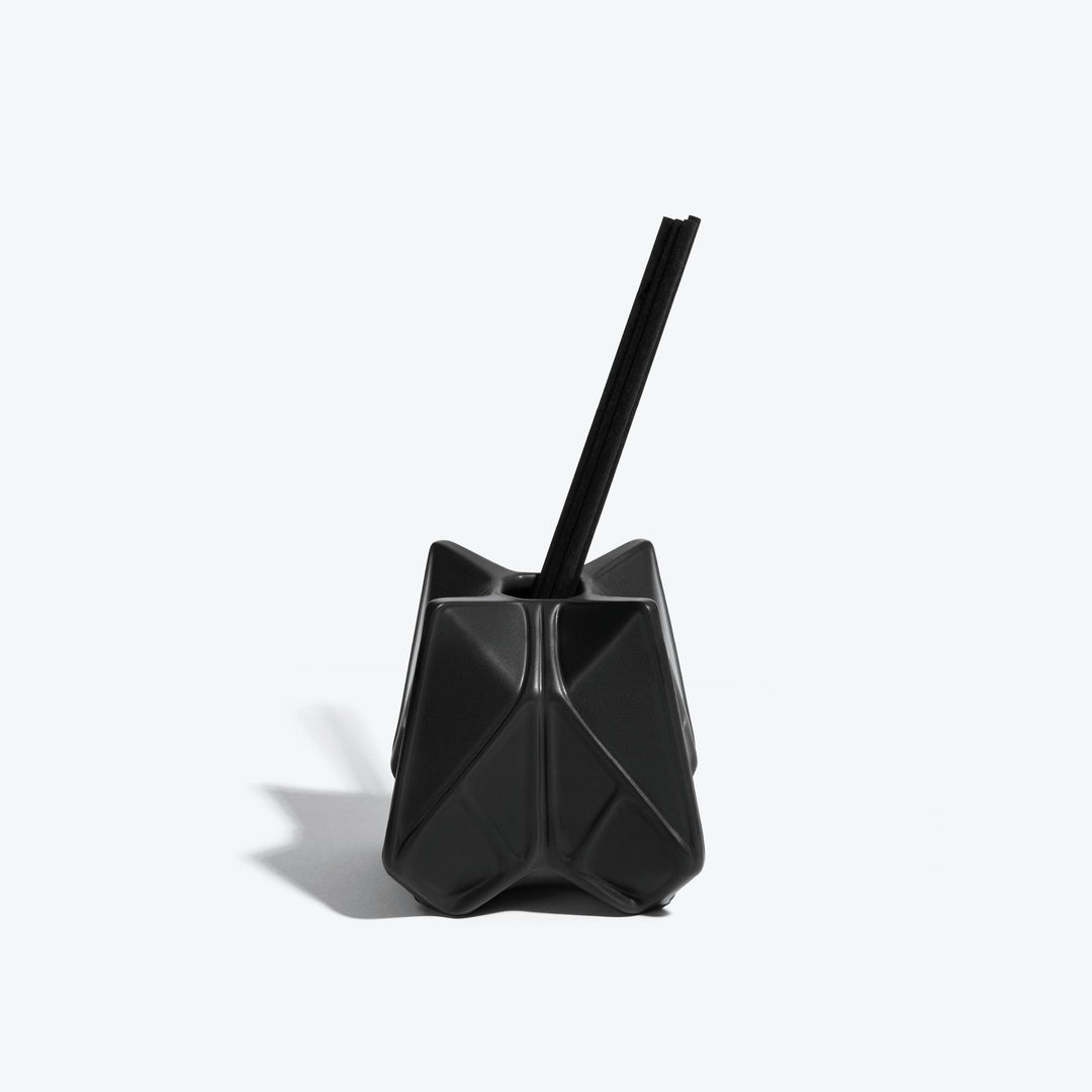Prime Reed Diffuser — black matte faceted diffuser with reeds, front view on a white background