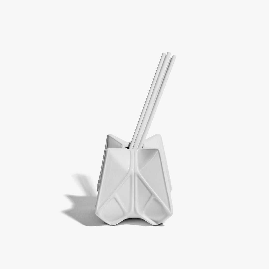 Prime Reed Diffuser — white glossy faceted diffuser with reeds, front view on a white background