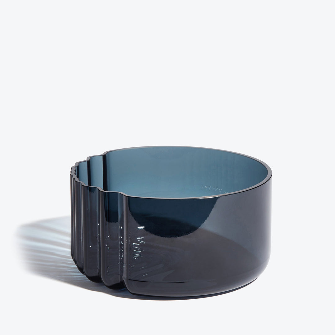 Pulse Bowl — Dark Blue glass bowl, side view showing the ribbed wave edge on white