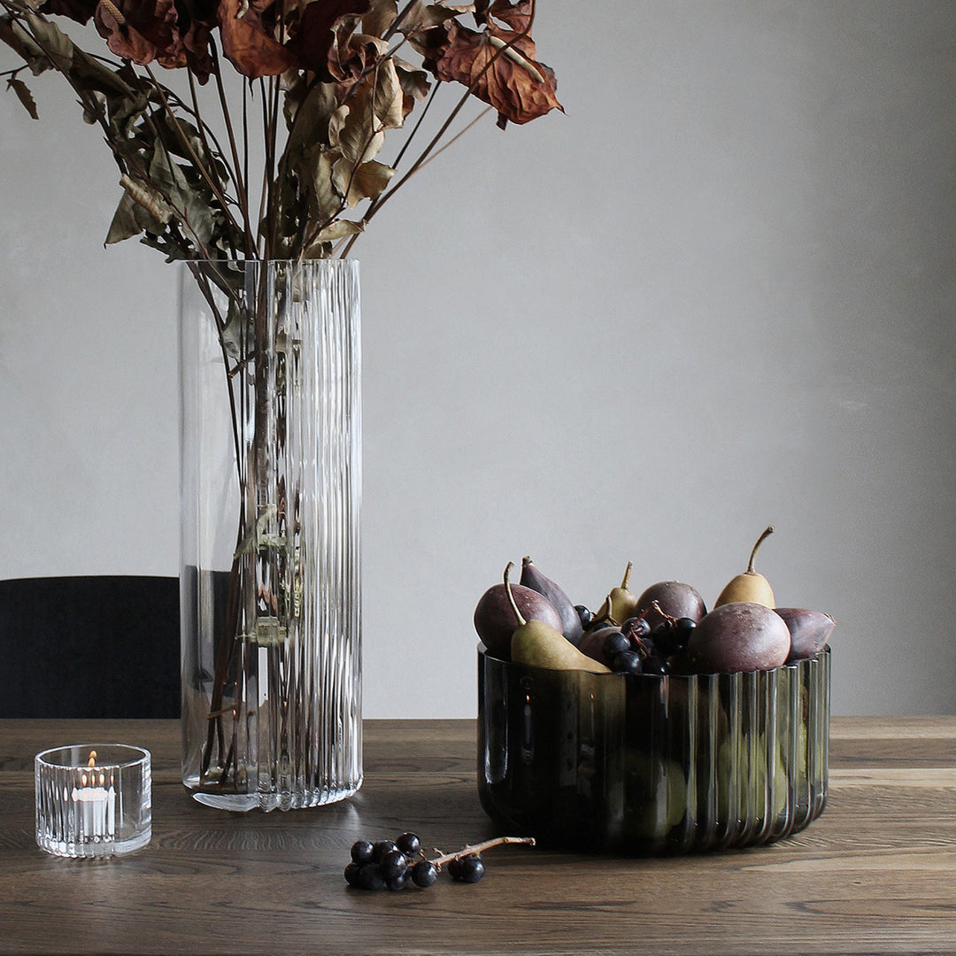 Pulse Bowl — Smoke glass bowl filled with figs and pears beside a clear vase on a wood table