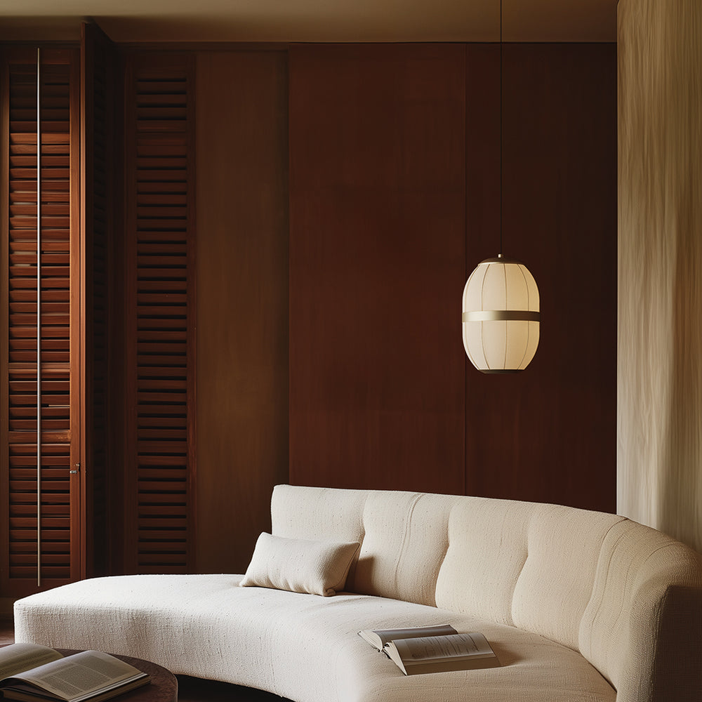Pull Large Pendant Lamp lit beside a curved cream sofa in a wood-panelled room