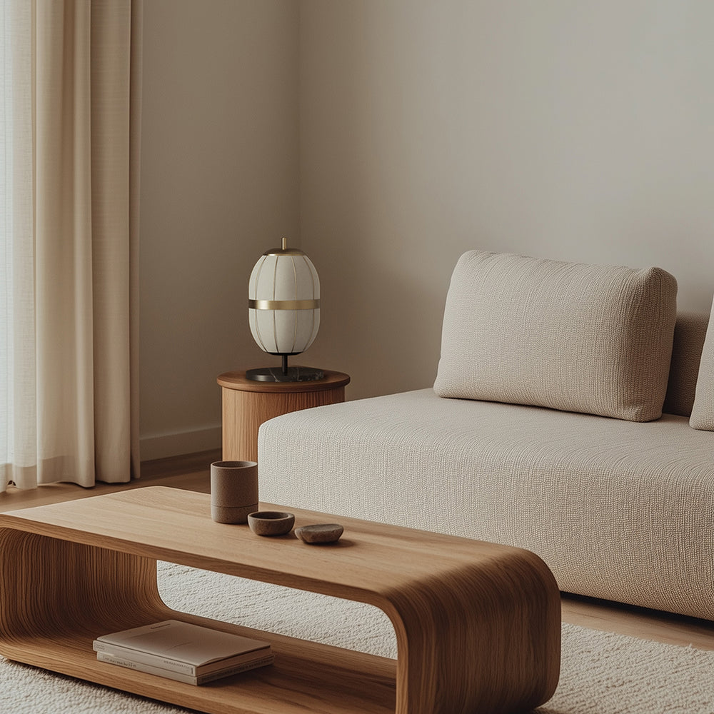 Pull Table Lamp with gold band on a wooden side table beside a cream sofa and low wood coffee table