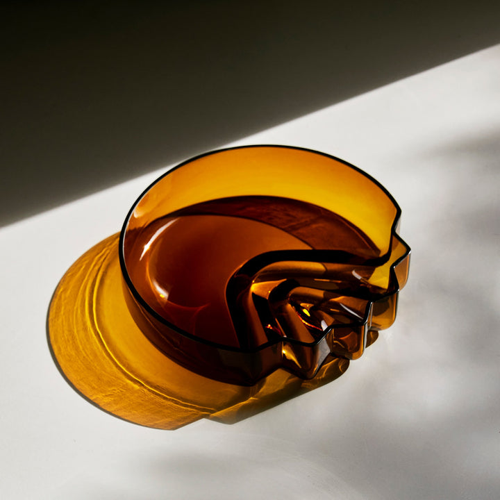 Pulse Platter — Amber glass platter in sunlight casting a golden shadow