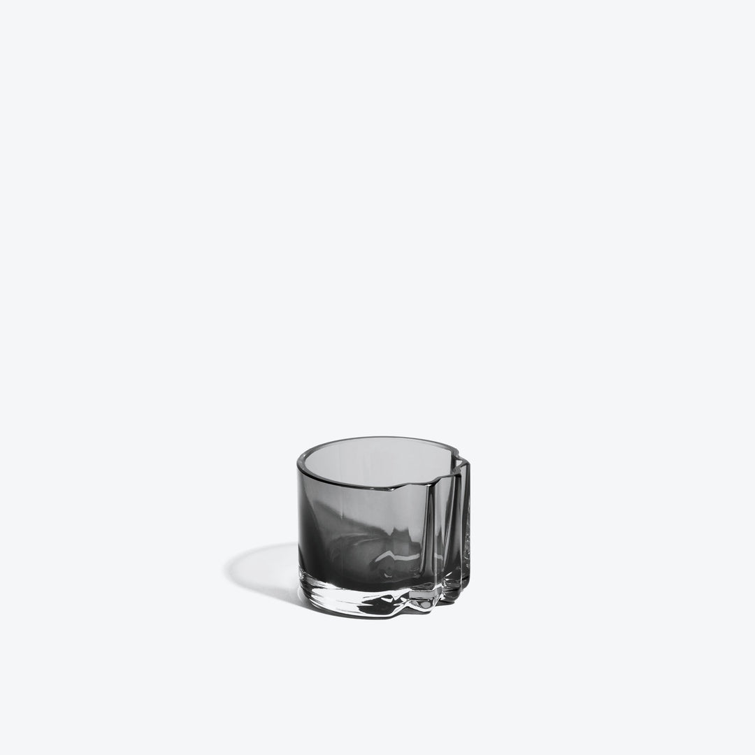 Pulse Tealight Holder V — Smoke glass tealight holder, side view with its notched fold on white