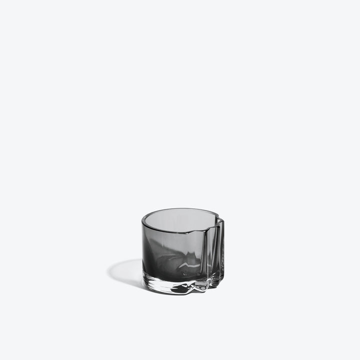 Pulse Tealight Holder V — Smoke glass tealight holder, side view with its notched fold on white