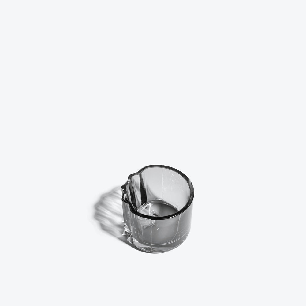 Pulse Tealight Holder V — Smoke glass tealight holder, three-quarter view into the interior on white