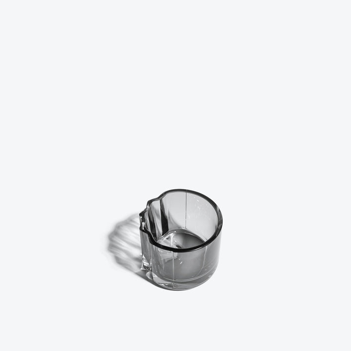 Pulse Tealight Holder V — Smoke glass tealight holder, three-quarter view into the interior on white