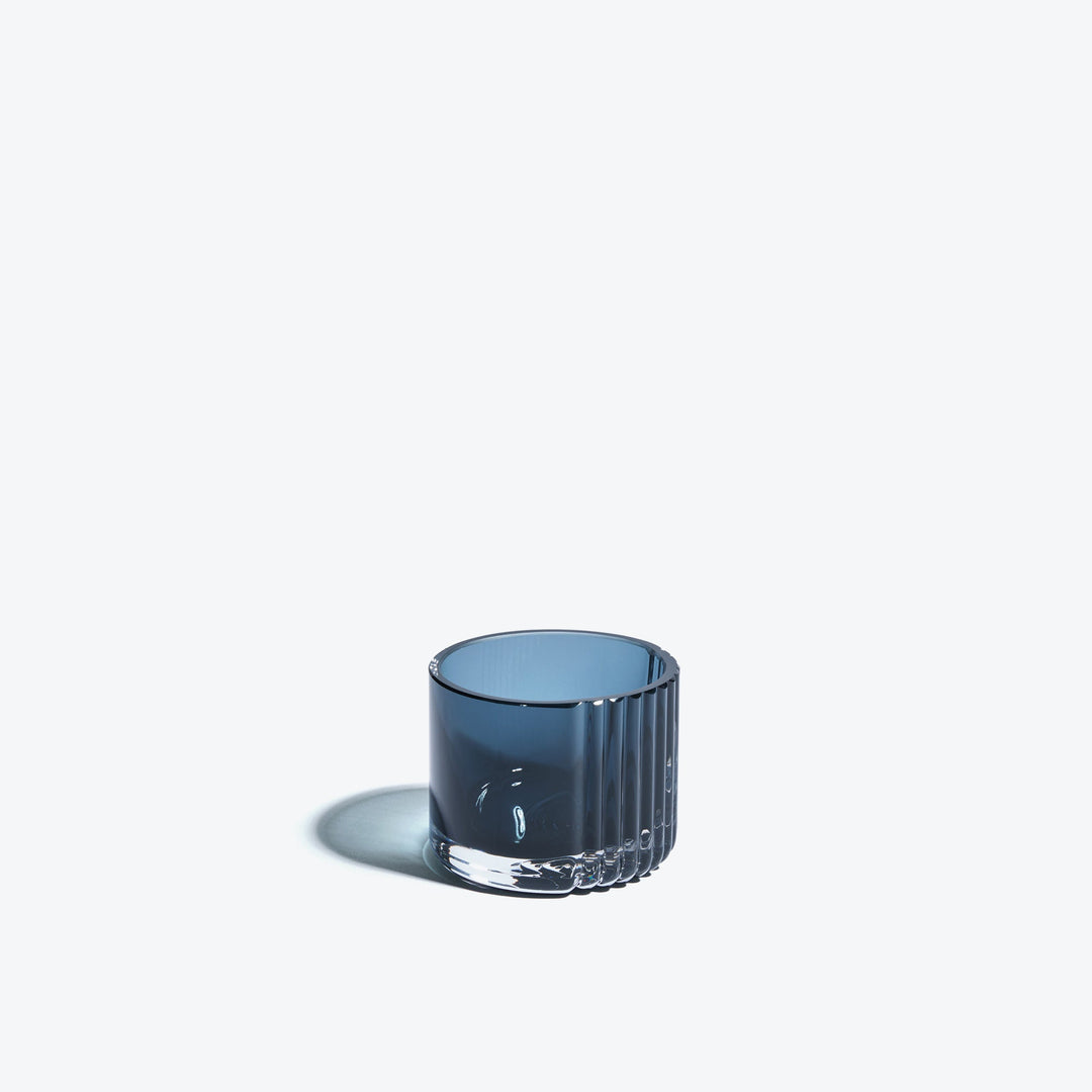 Pulse Tealight Holder X — dark blue ribbed glass tealight holder, front view on a white background