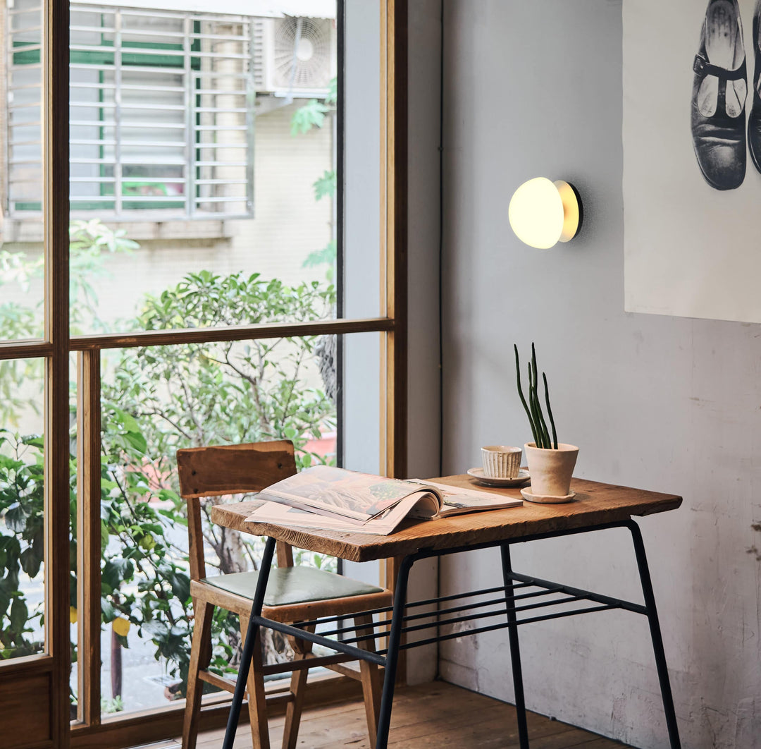 Pensee Wall Sconce by Seed Design, styled in a room setting