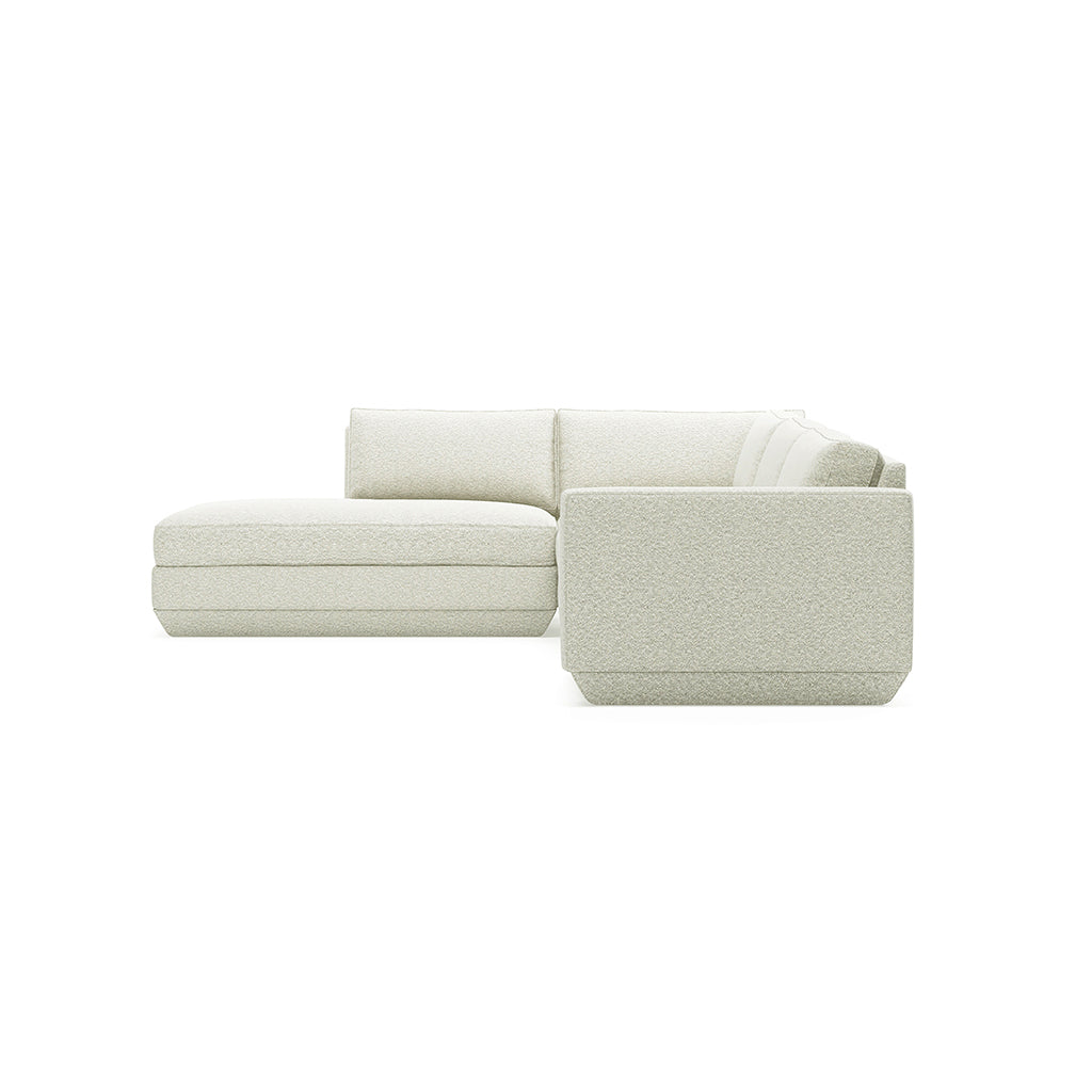 Elegant off-white sectional sofa with textured fabric, minimalist design for modern living spaces