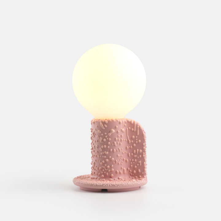 Pink textured ceramic table lamp with glowing orb shade