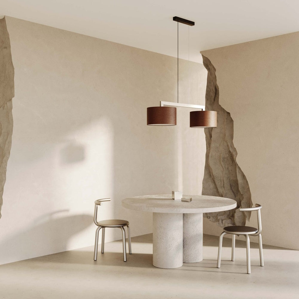 Rems Pendant Double with two brown leather shades over a round plaster dining table