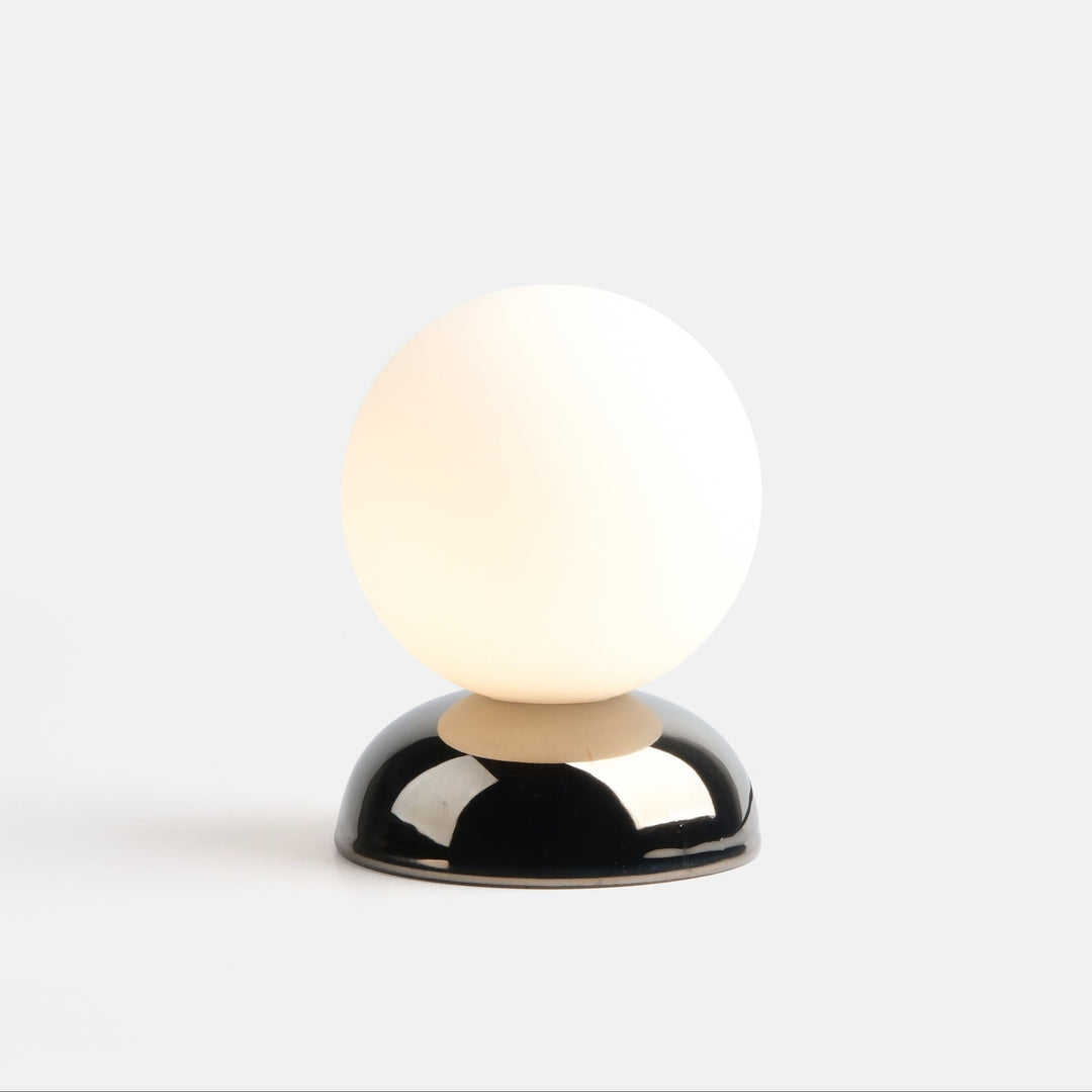 Globe lamp with frosted glass shade and glossy black base, modern designer lighting