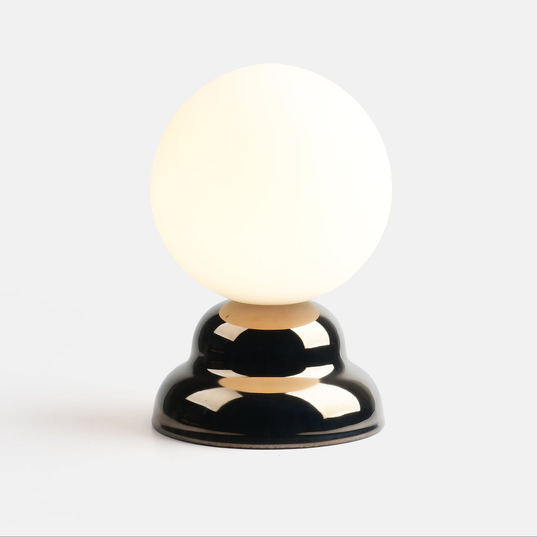 Globe lamp with glossy black base and frosted glass shade, modern designer lighting