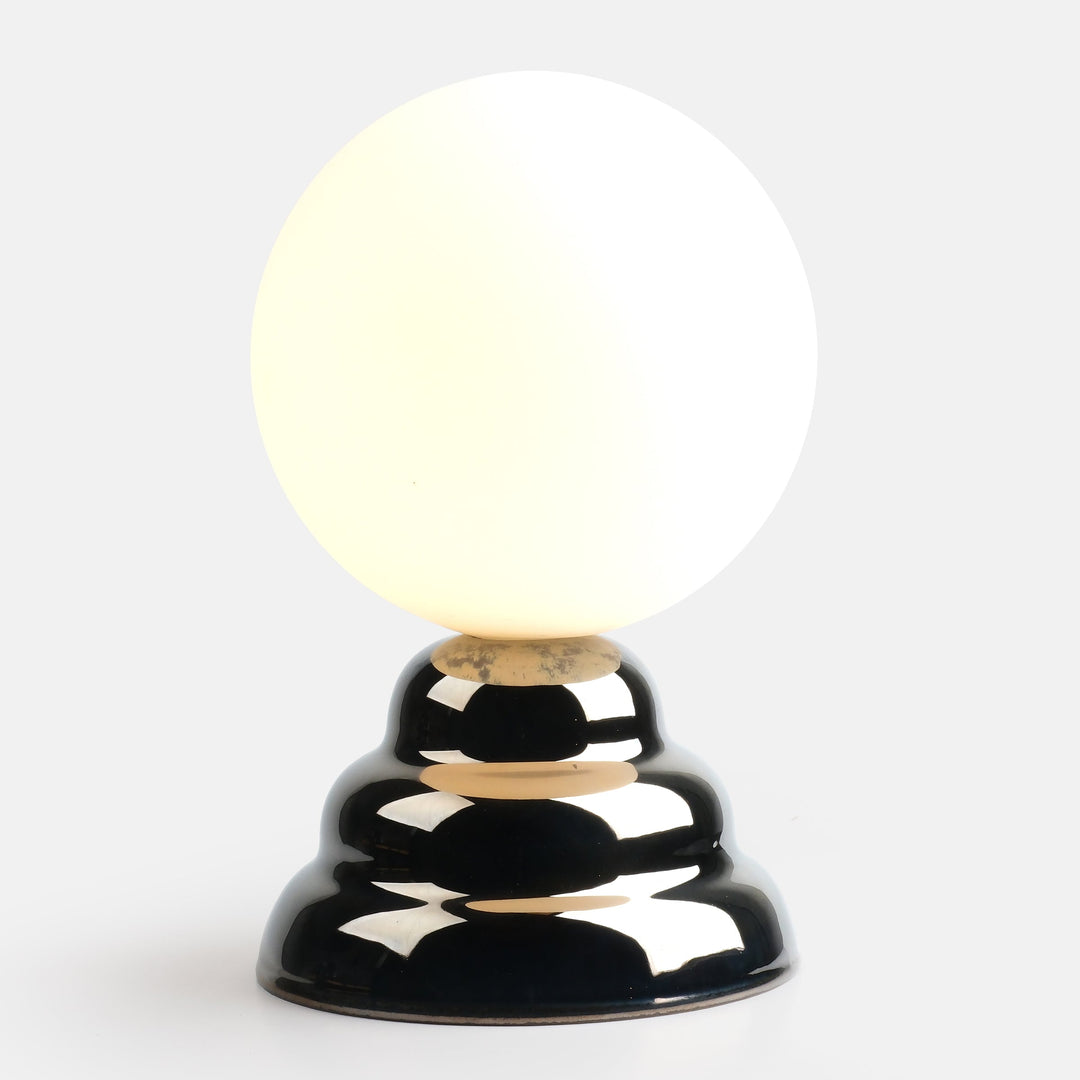 Glossy black ceramic lamp with spherical frosted glass shade, minimalist modern design