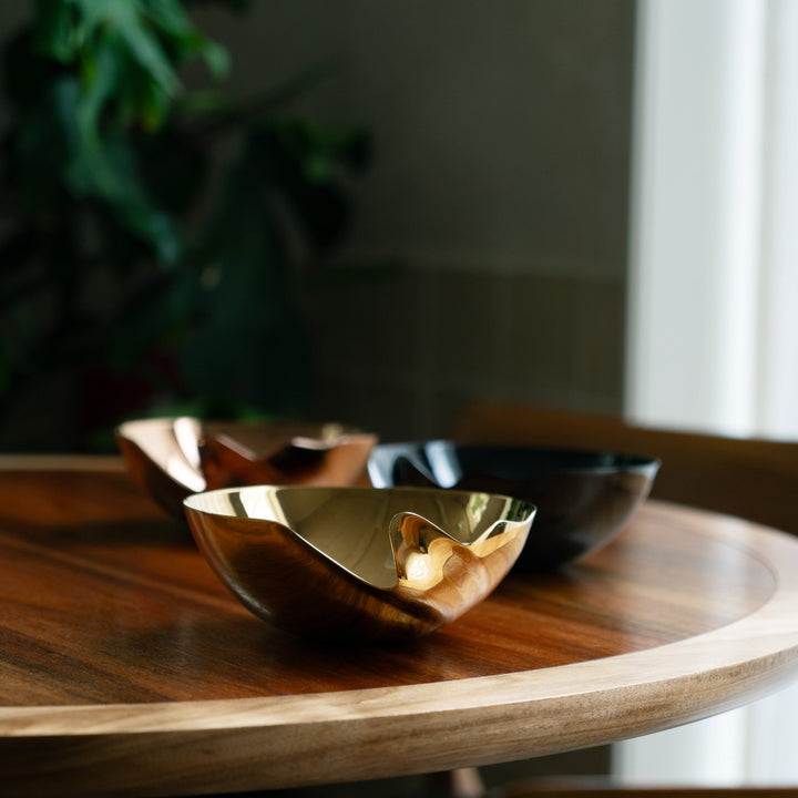 Serenity Bowl — gold, rose gold and black bowls grouped on a round wooden table