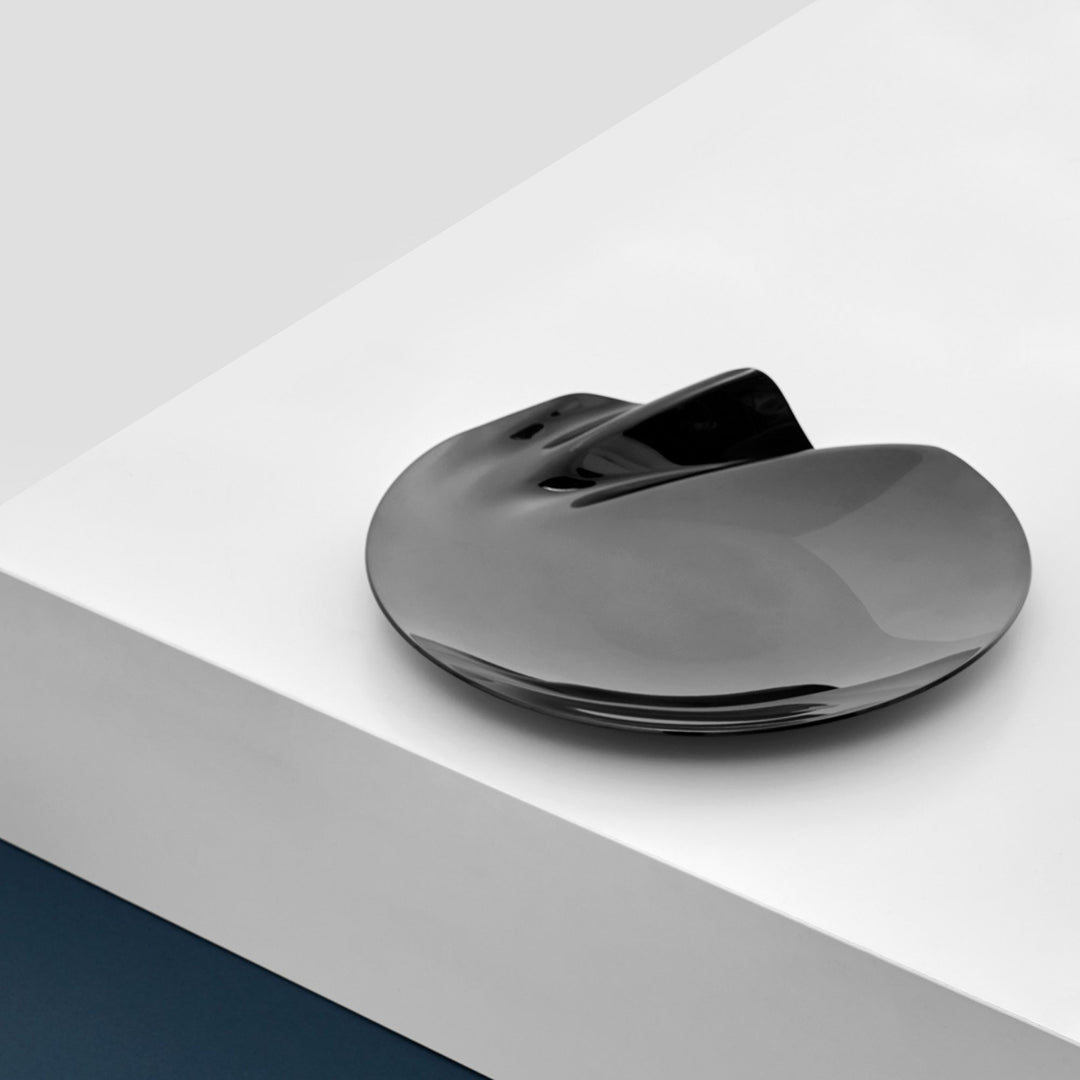 Serenity Platter — medium black platter with rippled edge on a white plinth, lifestyle view