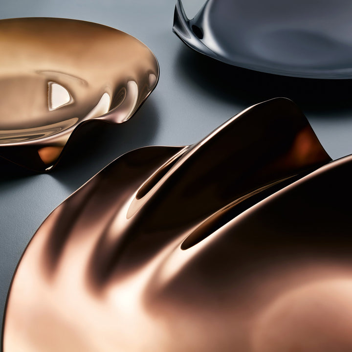 Serenity Platter — Rose Gold platters with a black platter behind, close lifestyle view of the rippled edges