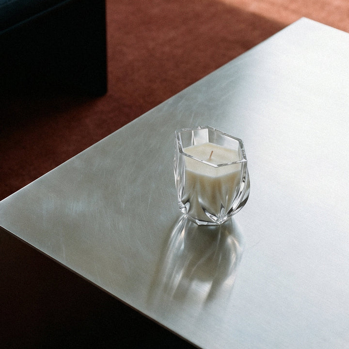Shimmer Scented Candle — Clear crystal candle on a brushed steel table, lifestyle