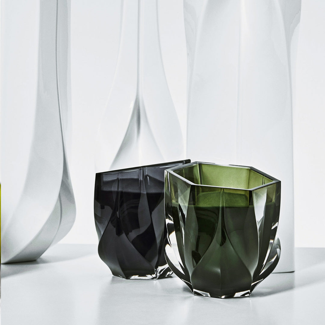 Shimmer Scented Candle — Olive Green candle beside a dark smoke candle against white sculpted forms