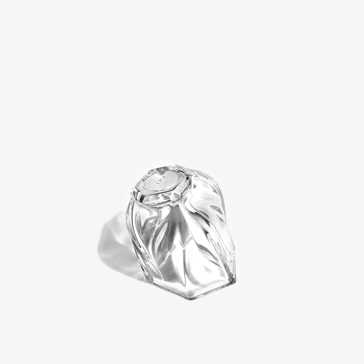 Shimmer Tealight Holder — Clear holder tipped on its side, showing the twisted faceted base