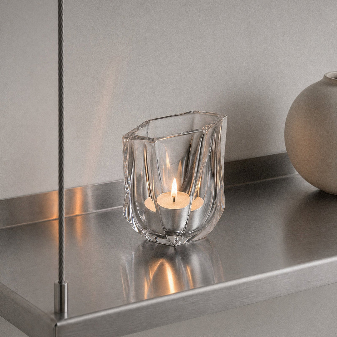 Shimmer Tealight Holder — Clear holder with a lit tealight on a brushed steel shelf