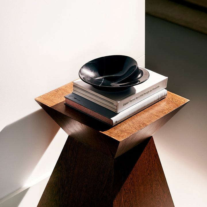 Swirl Bowl — small Black Marble bowl on a stack of books atop a wood pedestal