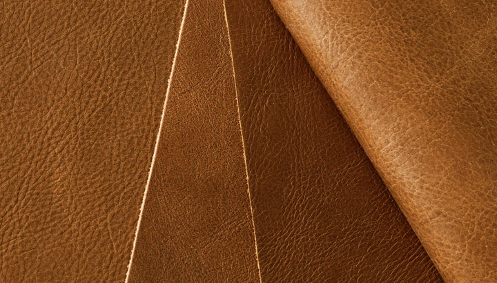 Rich brown leather upholstery with precise stitching, showcasing premium material texture.
