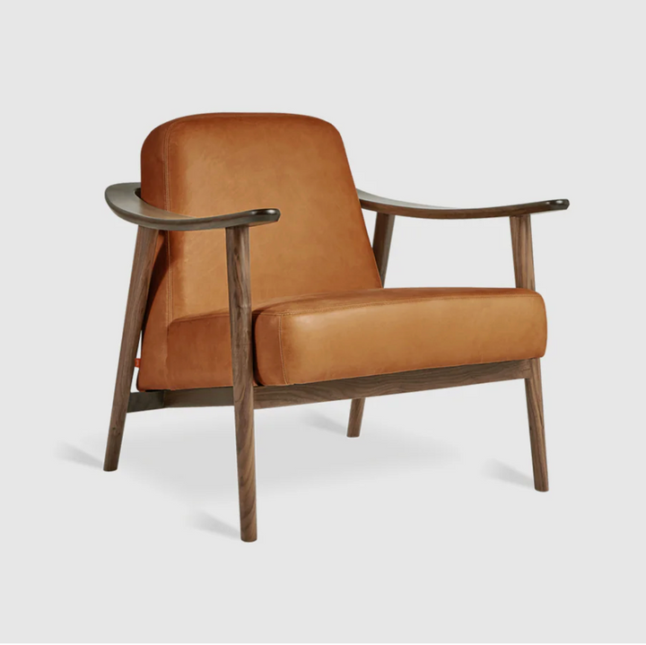 Mid-century modern armchair in caramel leather with walnut wood frame, designer lounge chair