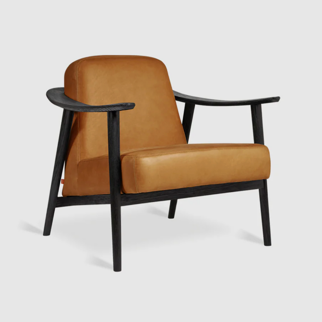 Caramel leather armchair with dark wood frame, modern designer furniture