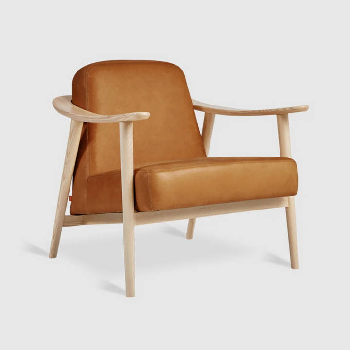Tan leather armchair with light wood frame, modern designer furniture
