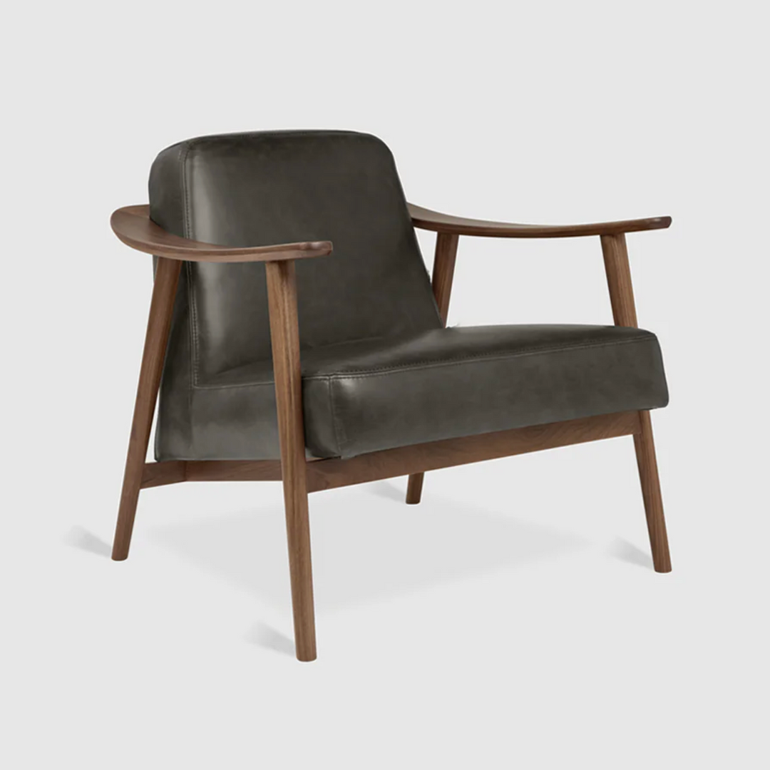 Mid-century modern leather armchair with walnut wood frame, elegant designer furniture