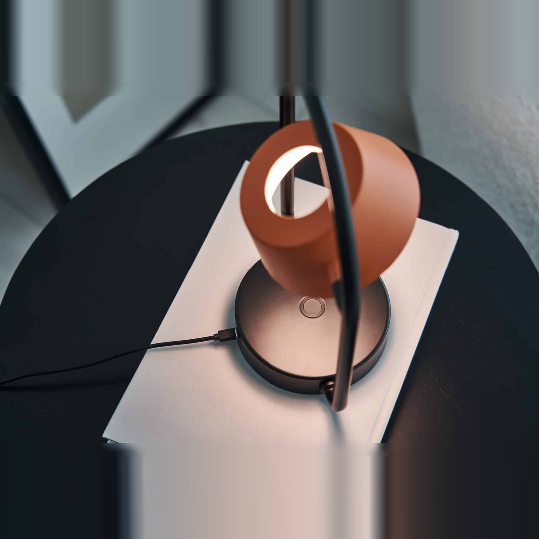 Olo Ring Portable Table Lamp by Seed Design in Coral Orange, styled in a room setting