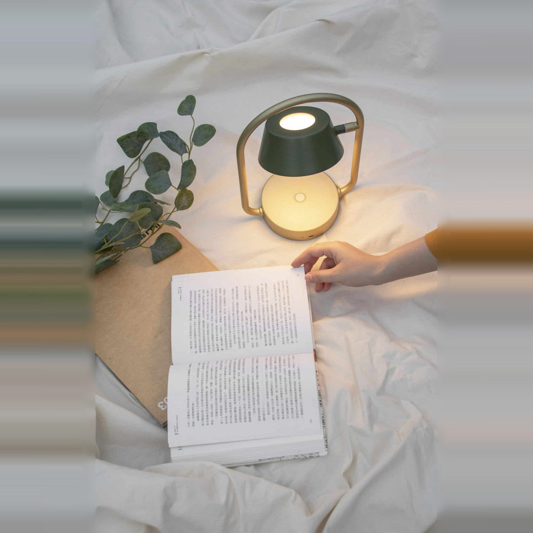 Olo Ring Portable Table Lamp by Seed Design in Olive Green, styled in a room setting