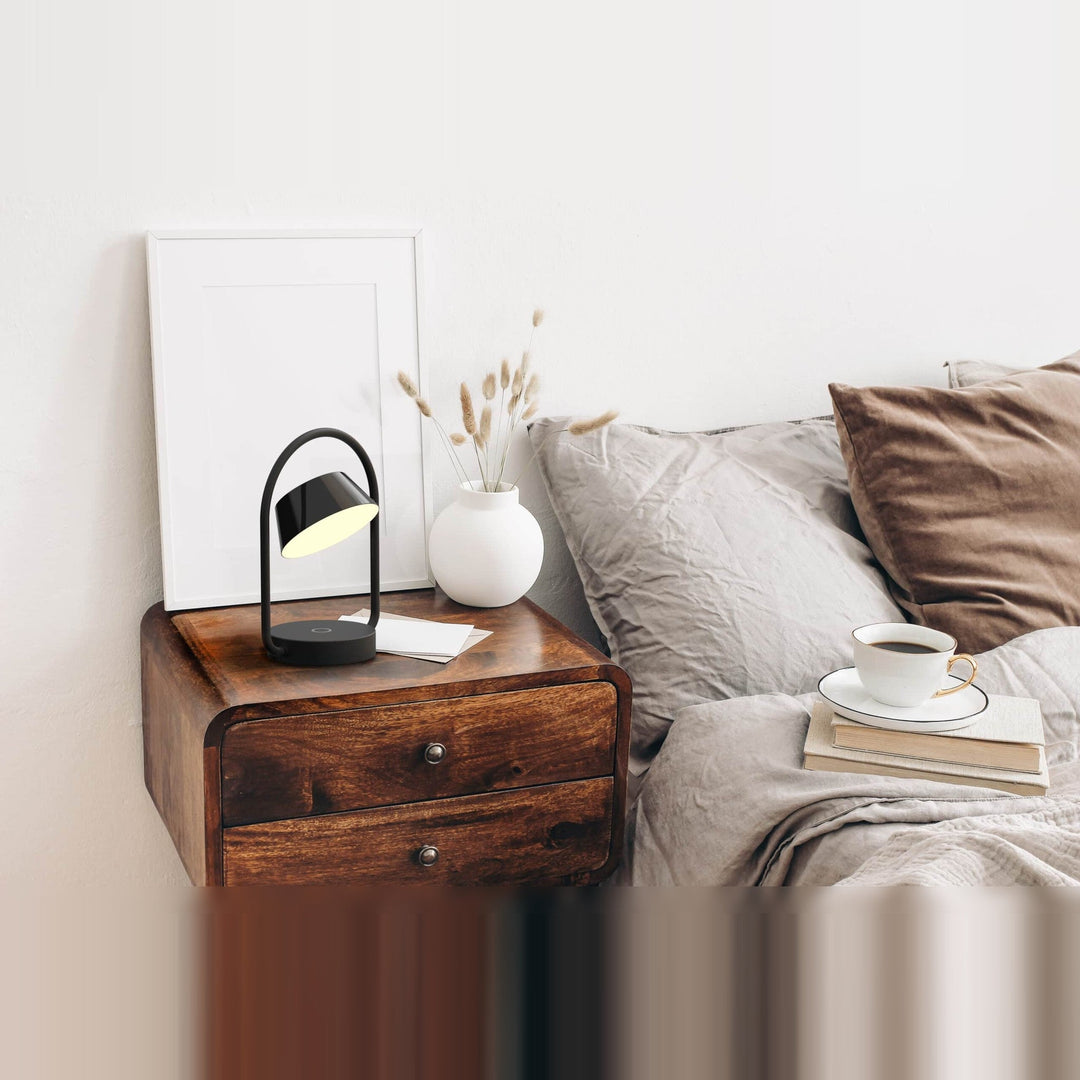 Olo Ring Portable Table Lamp by Seed Design in Black, styled in a room setting