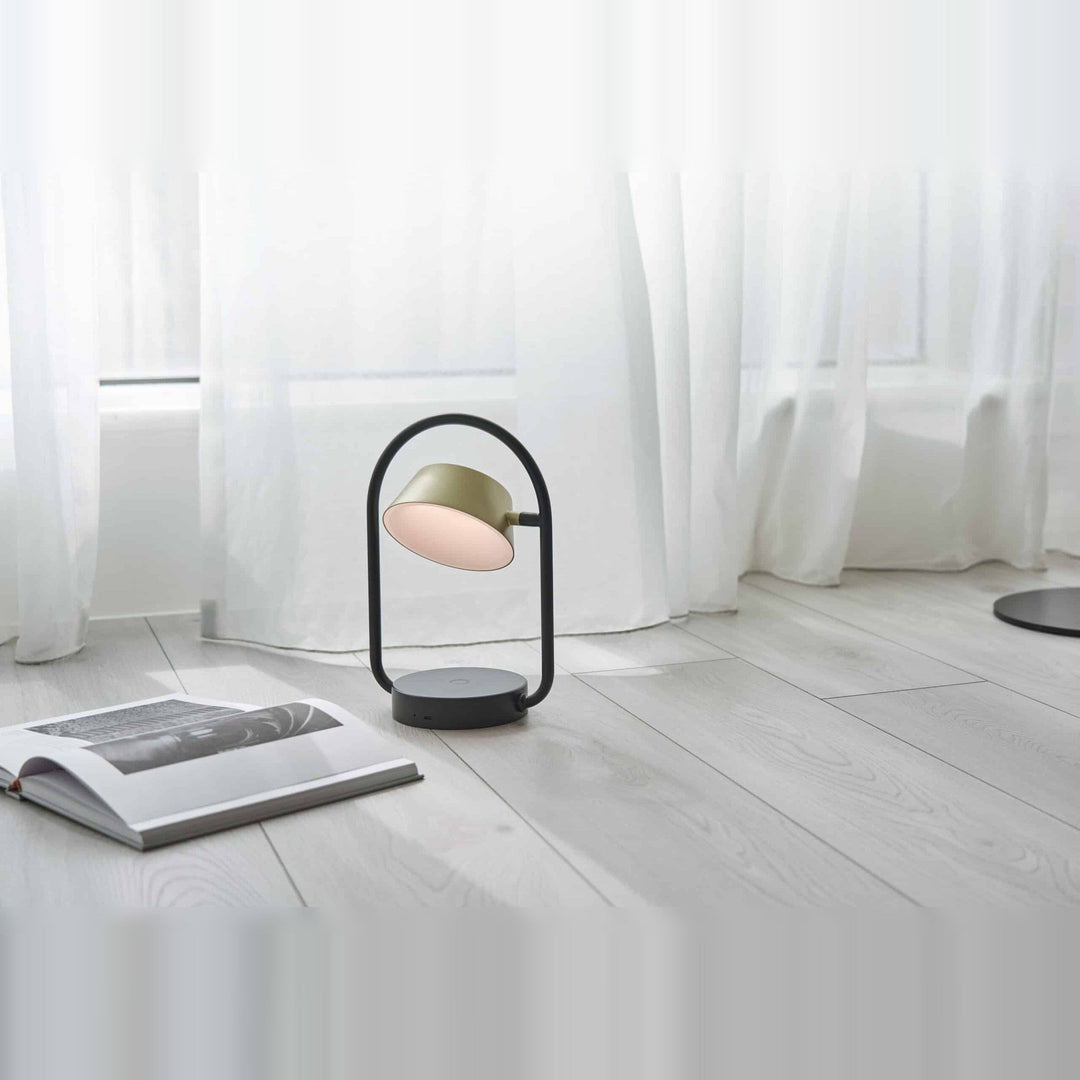 Olo Ring Portable Table Lamp by Seed Design in Champagne Gold, styled in a room setting
