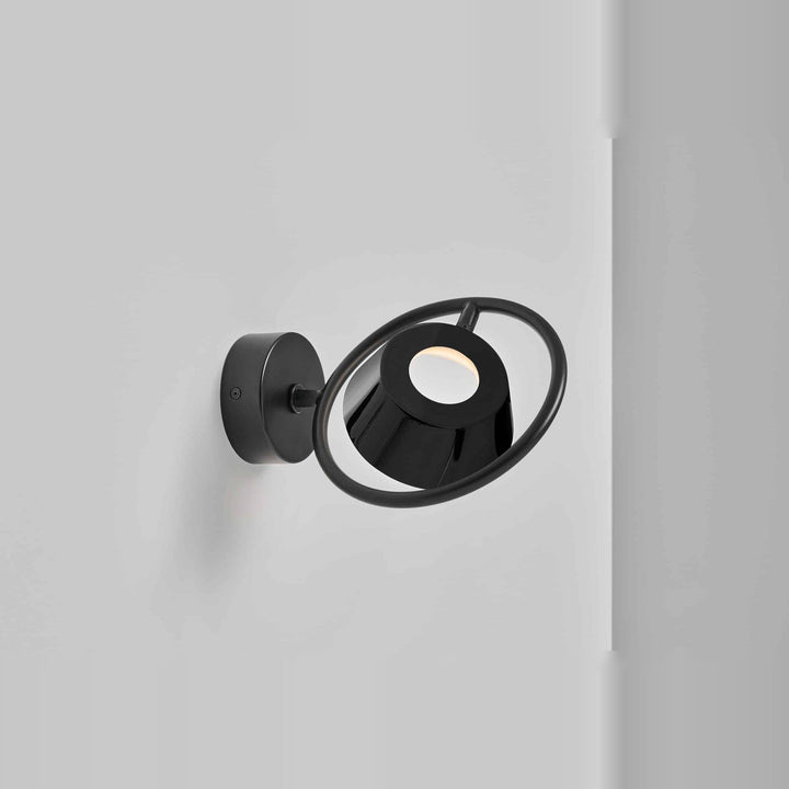 Olo Ring Wall Lamp by Seed Design in Black, styled in a room setting