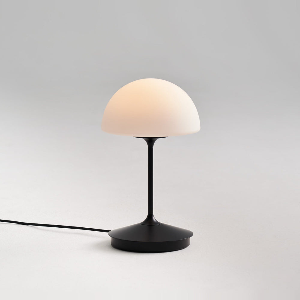 Pensee Table Lamp by Seed Design in Black, styled in a room setting
