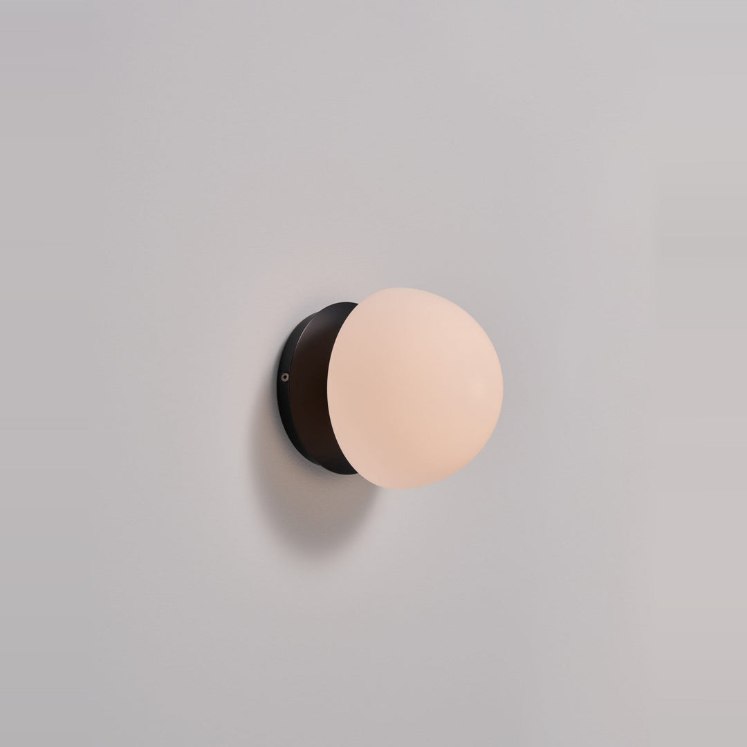 Pensee Wall Sconce by Seed Design in Black, studio shot